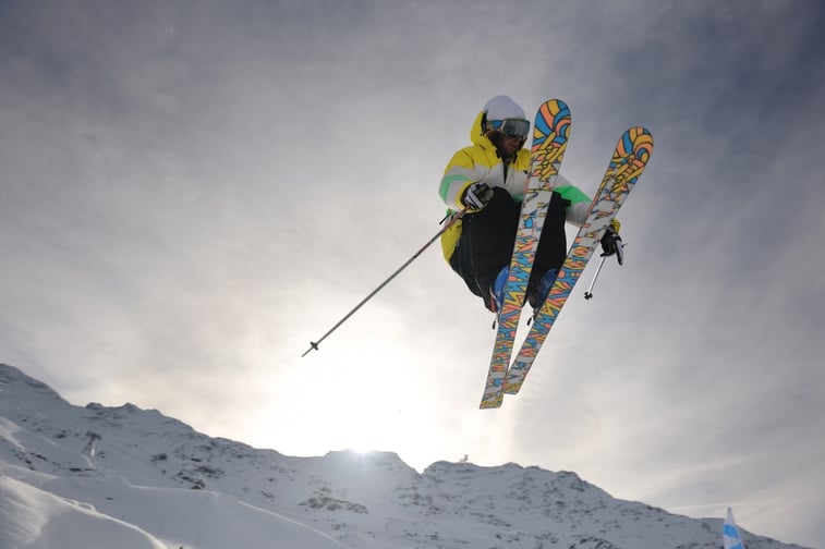 extreme freestyle ski jump with young man at mountain in snow park at winter season.jpeg